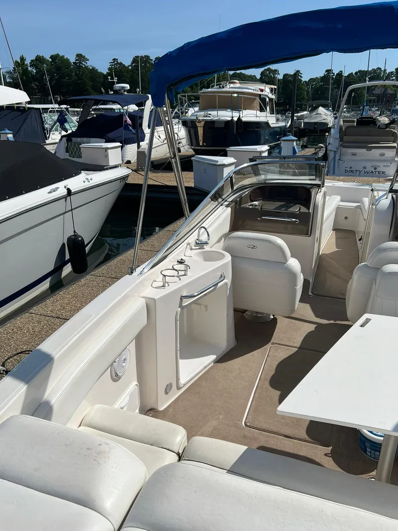 Slide: The Image of 2006 Regal 2600 Bowrider boat docked at a marina. - 11