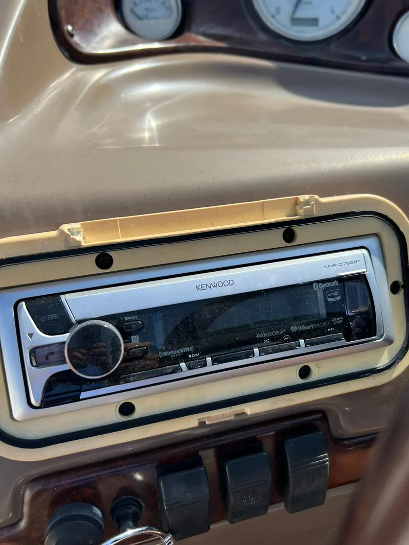 Slide: The Image of Kenwood stereo system on a 2006 Regal 2600 Bowrider boat dashboard. - 16