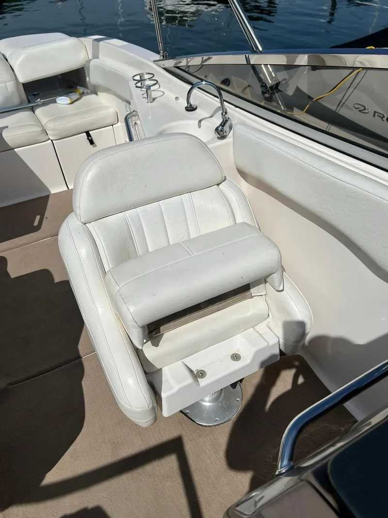 Slide: The Image of 2006 Regal 2600 Bowrider boat interior with white captain's chair. - 19