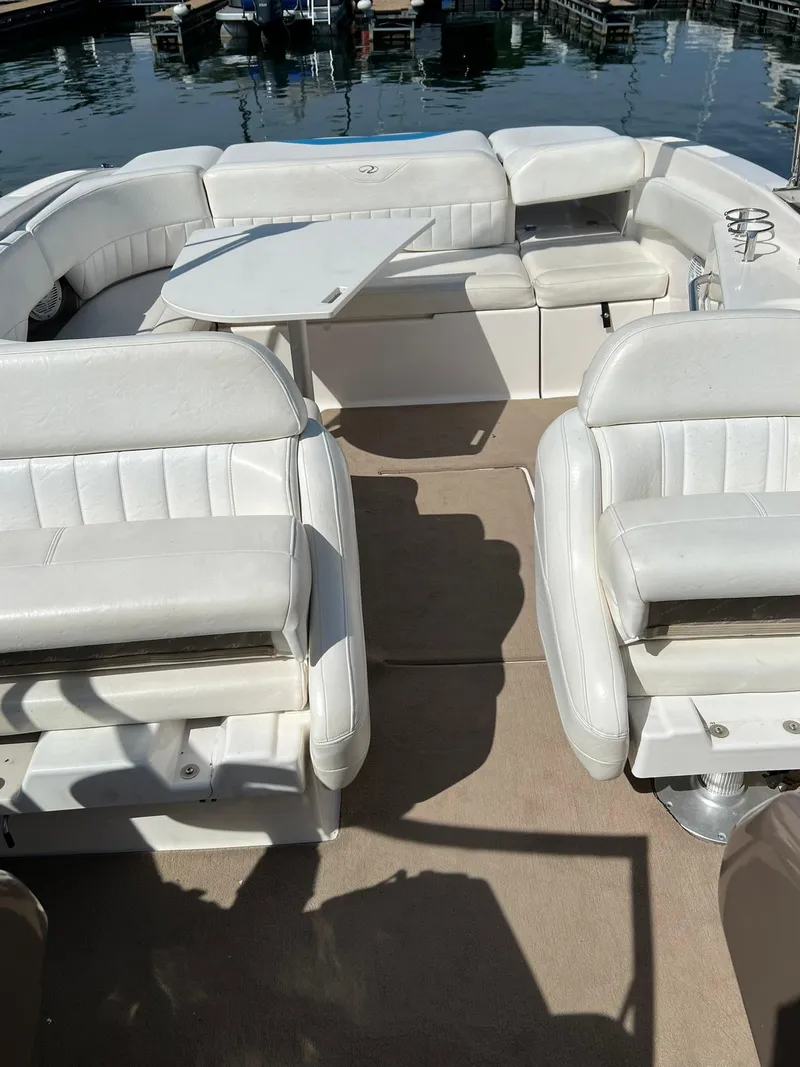 Slide: The Image of 2006 Regal 2600 Bowrider boat interior with white seating and table. - 20