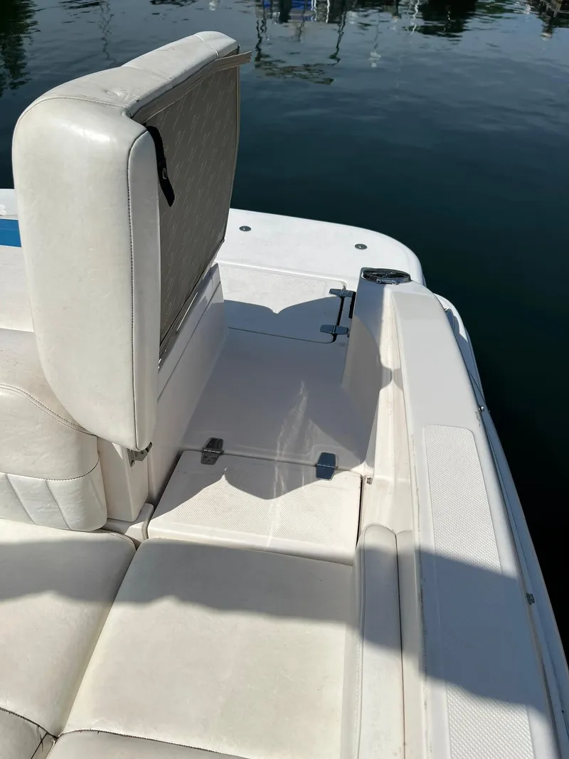 Slide: The Image of 2006 Regal 2600 Bowrider boat interior seating area near water. - 27