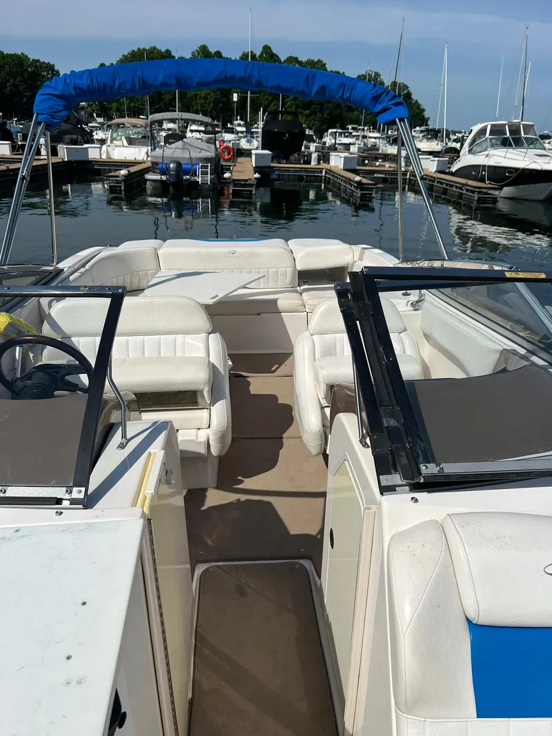 Slide: The Image of 2006 Regal 2600 Bowrider boat docked at a marina. - 29