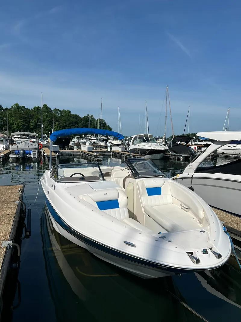 Slide: The Image of 2006 Regal 2600 Bowrider docked at a marina on a sunny day. - 5