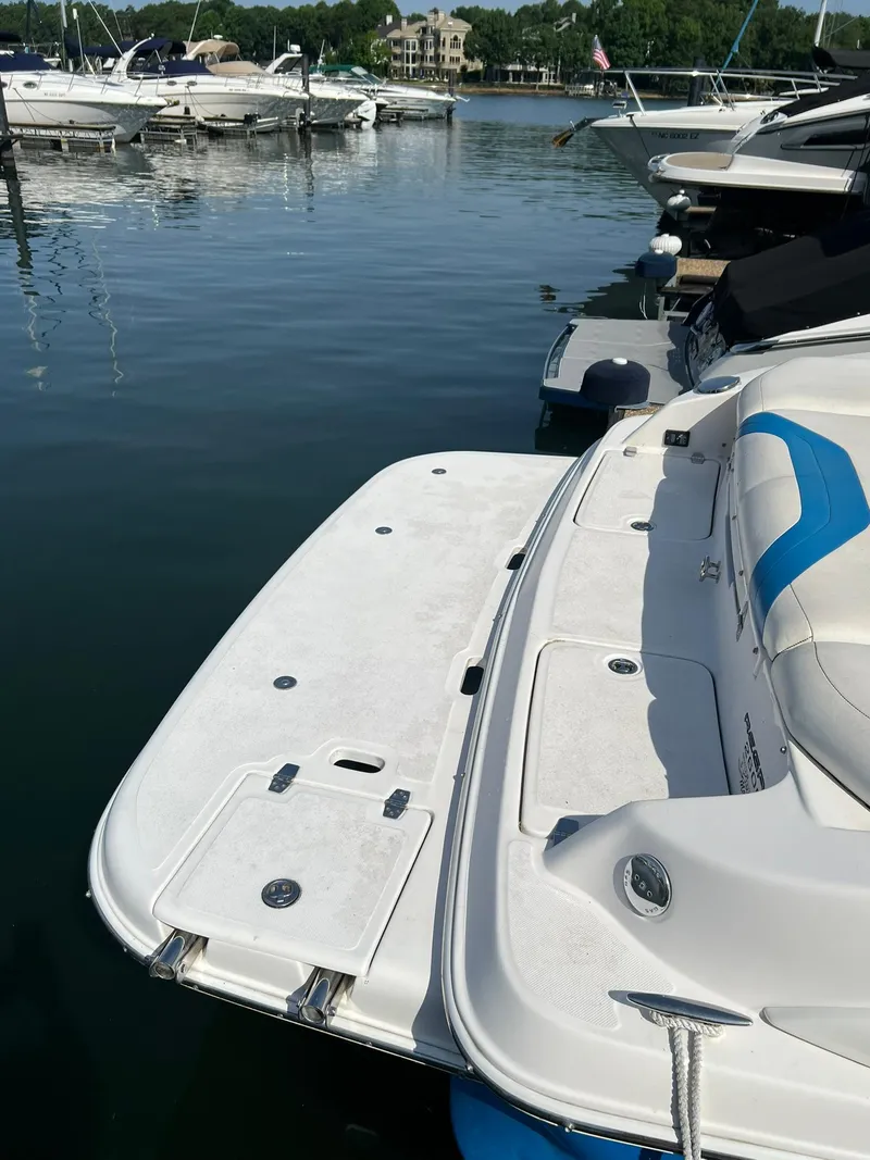 Slide: The Image of 2006 Regal 2600 Bowrider docked at a marina. - 6