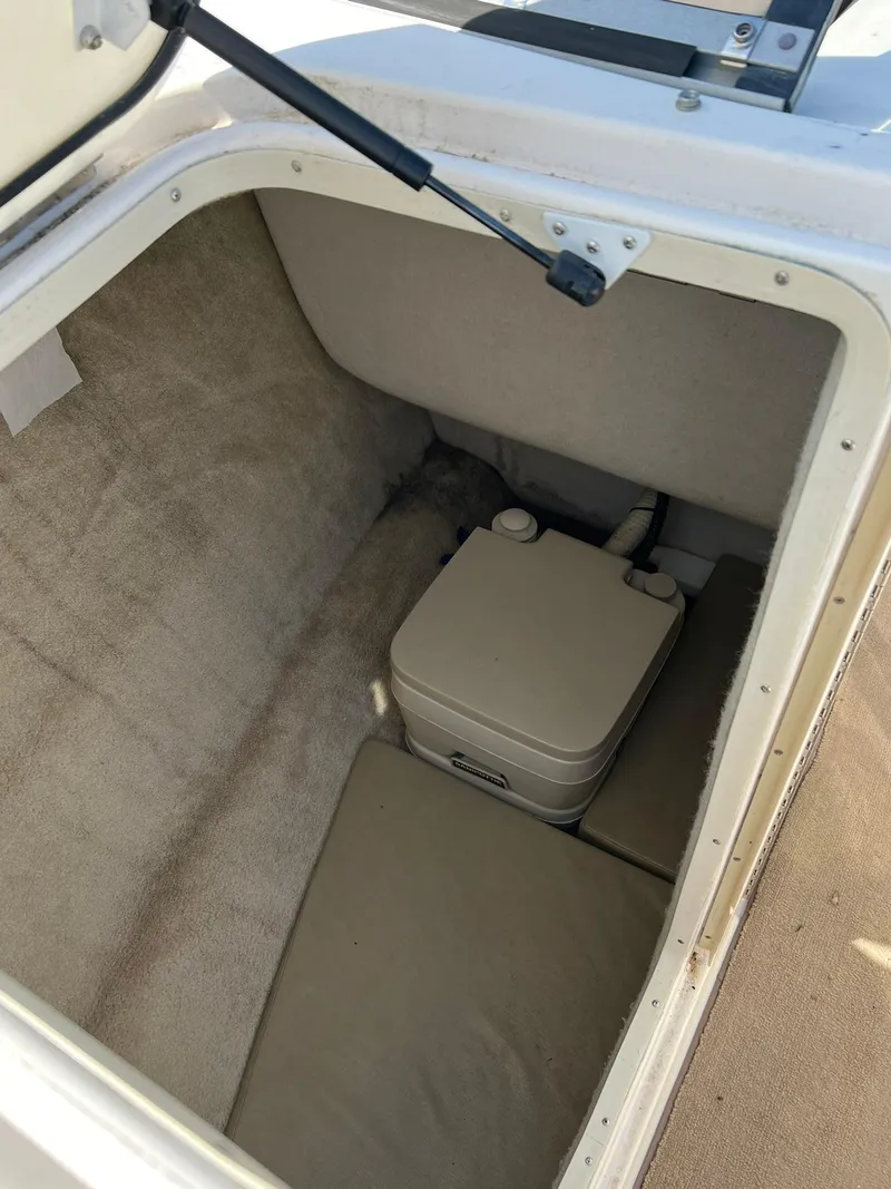 Slide: The Image of 2006 Regal 2600 Bowrider boat interior storage compartment with portable toilet. - 9
