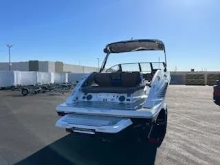 Slide: The Image of 2024 Scarab 285 Wake ID boat in a parking lot under clear blue sky. - 3