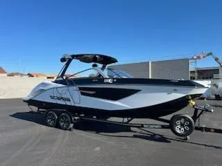 Slide: The Image of 2024 Scarab 285 Wake ID boat on a trailer in a parking lot. - 7