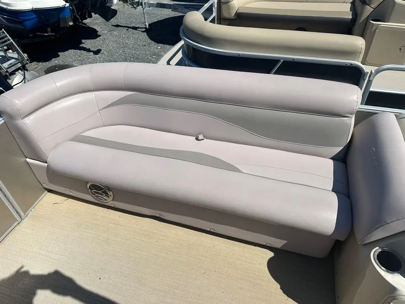 Slide: The Image of 2015 Godfrey 2286 Sweetwater Pontoon boat seating area with beige and gray upholstery. - 10