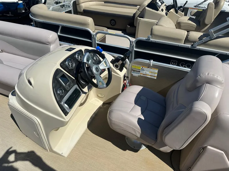 Slide: The Image of 2015 Godfrey 2286 Sweetwater Pontoon boat interior with steering console and seating. - 3