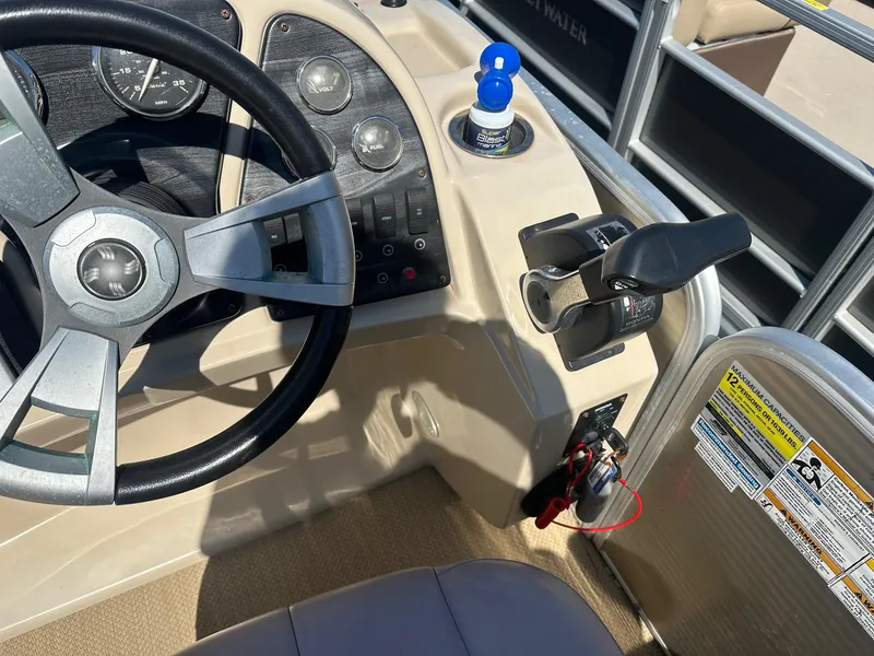 Slide: The Image of 2015 Godfrey 2286 Sweetwater Pontoon boat steering console with controls and gauges. - 4