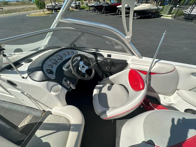 Slide: The Image of 2006 Tigé 22i boat interior with steering wheel and dashboard controls. - 13