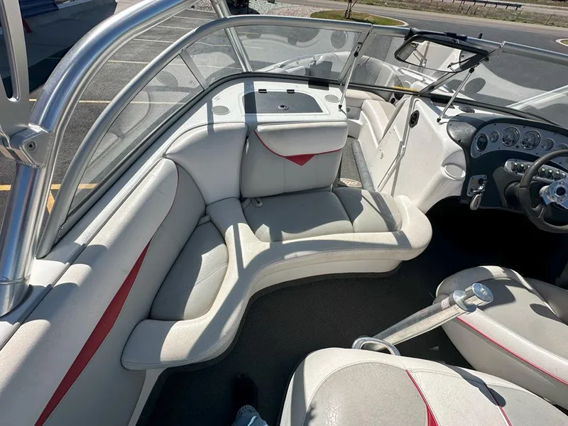 Slide: The Image of 2006 Tigé 22i boat interior with white and red seating, steering wheel, and dashboard. - 14