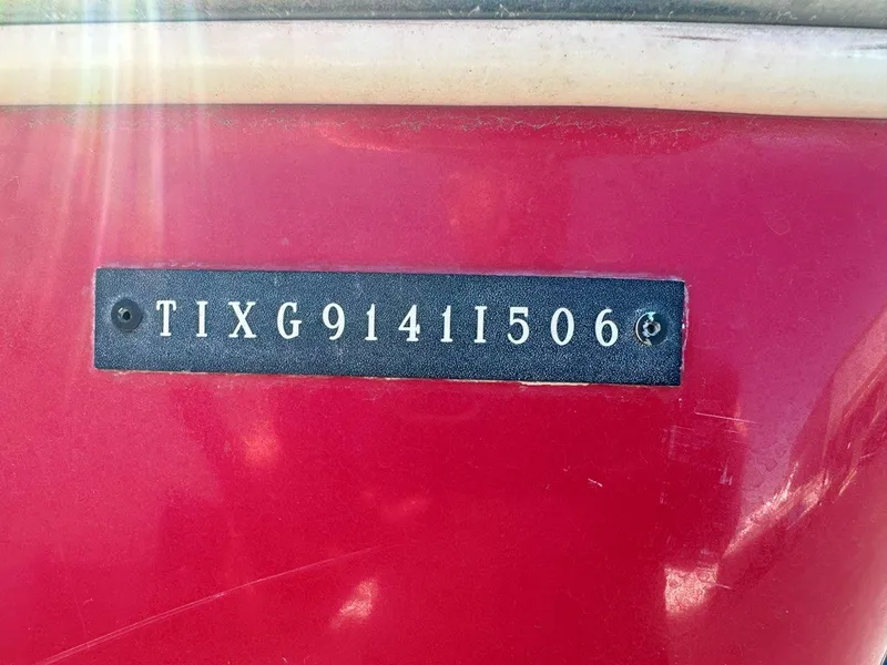 Slide: The Image of 2006 Tigé 22i boat hull identification number on red surface. - 18