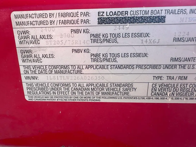 Slide: The Image of Label on 2006 Tigé 22i boat trailer, showing manufacturer details and VIN. - 19