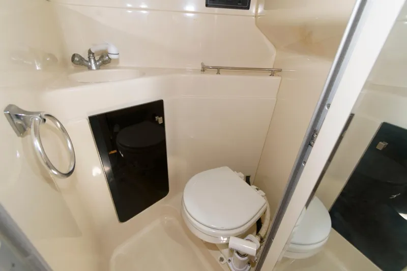 Slide: The Image of 1995 Wellcraft 2800 Martinique boat bathroom with toilet and sink. - 10