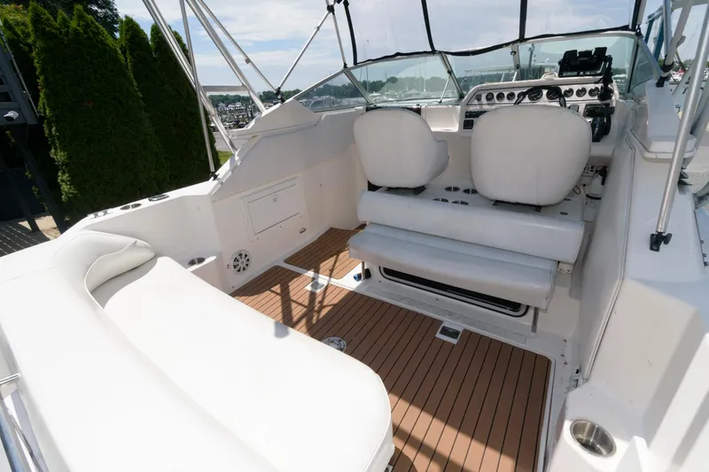 Slide: The Image of 1995 Wellcraft 2800 Martinique boat interior with white seating and wooden flooring. - 3