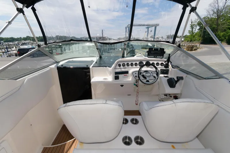Slide: The Image of 1995 Wellcraft 2800 Martinique boat cockpit with dual seats and steering console. - 5