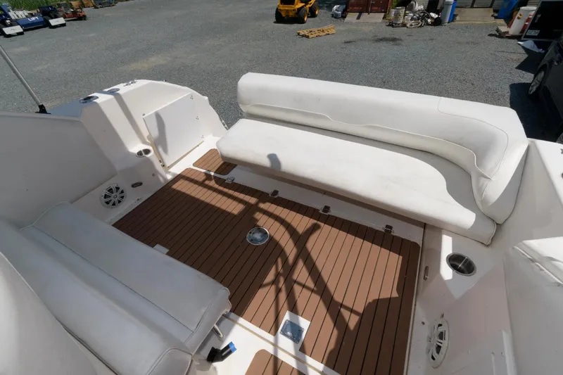Slide: The Image of 1995 Wellcraft 2800 Martinique boat interior with white seating and wooden deck. - 6