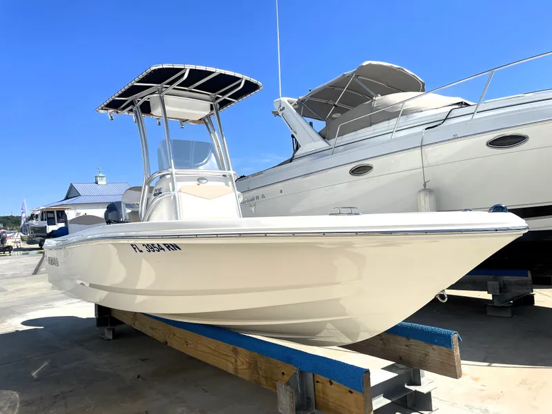 Slide: The Image of 2018 Robalo 206 Cayman boat on display at a marina. - 0