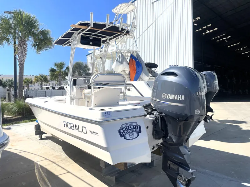 Slide: The Image of 2018 Robalo 206 Cayman boat with Yamaha engine in marina. - 1