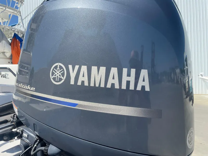 Slide: The Image of Close-up of a Yamaha outboard motor on a 2018 Robalo 206 Cayman boat. - 12