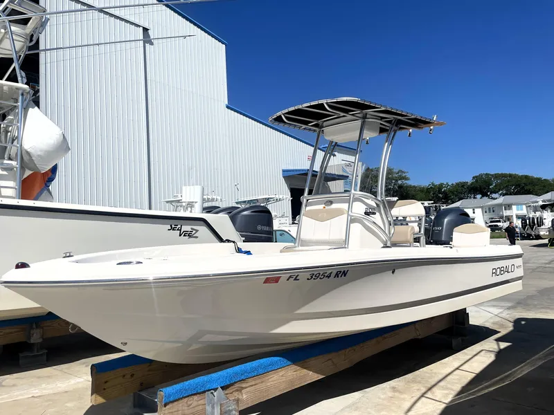 Slide: The Image of 2018 Robalo 206 Cayman boat on display at a marina under clear blue sky. - 2