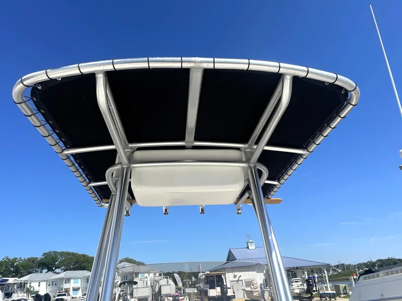 Slide: The Image of 2018 Robalo 206 Cayman boat with T-top at marina. - 24