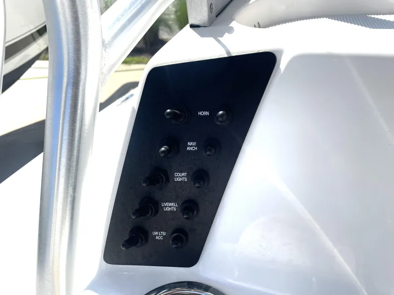 Slide: The Image of Control panel of a 2018 Robalo 206 Cayman boat with various switches. - 30