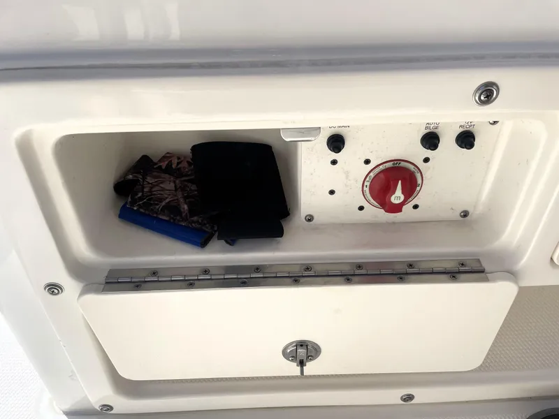 Slide: The Image of Storage compartment and control panel on a 2018 Robalo 206 Cayman boat. - 34
