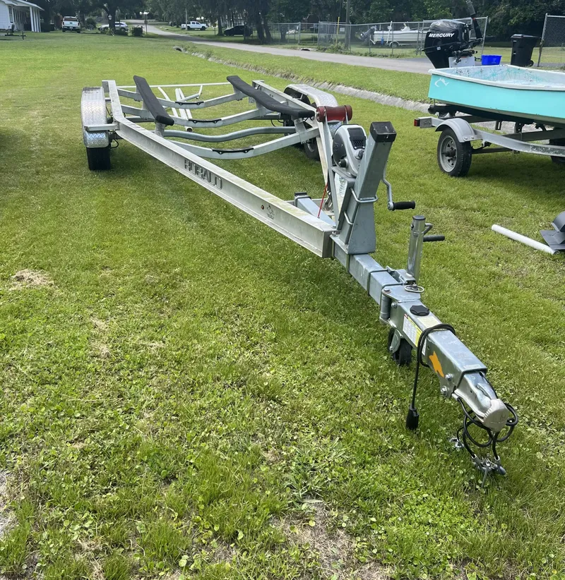 Slide: The Image of Boat trailer for 2018 Robalo 206 Cayman on grassy field. - 4