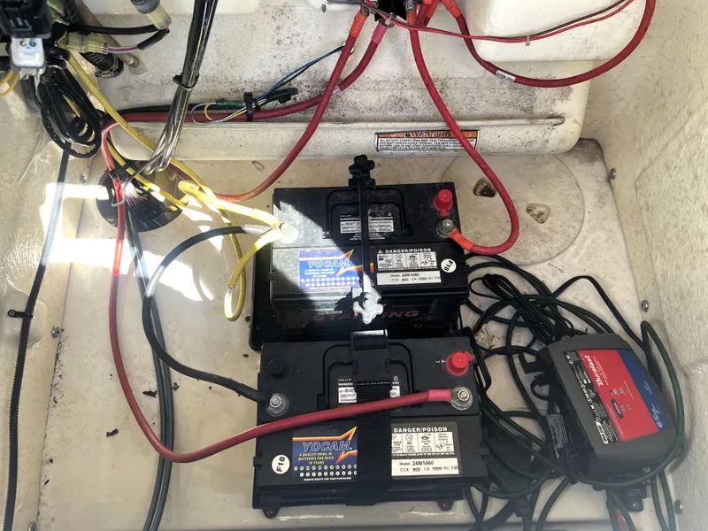Slide: The Image of 2018 Robalo 206 Cayman boat battery compartment with wiring and charger. - 45