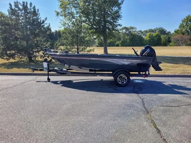 Slide: The Image of 2024 Ranger VS1665T fishing boat on trailer, parked outdoors. - 0