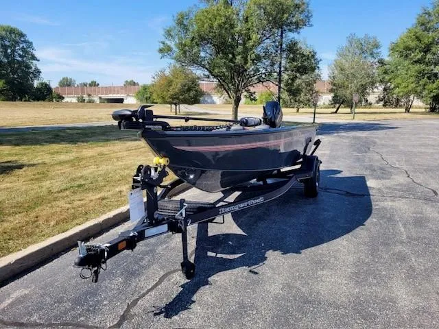 Slide: The Image of 2024 Ranger VS1665T boat on trailer in sunny park setting. - 1