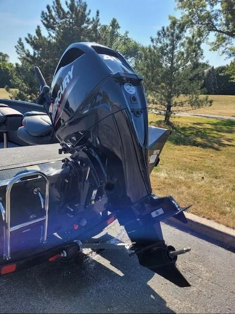 Slide: The Image of 2024 Ranger VS1665T boat with Mercury outboard motor, parked outdoors. - 2