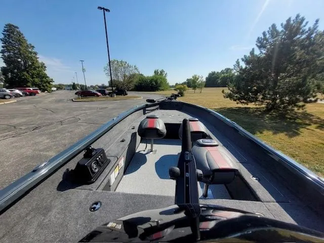 Slide: The Image of 2024 Ranger VS1665T boat in a parking lot, showcasing interior seating and controls. - 3