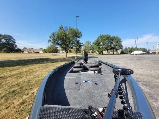 Slide: The Image of 2024 Ranger VS1665T boat on grassy area under clear blue sky. - 4