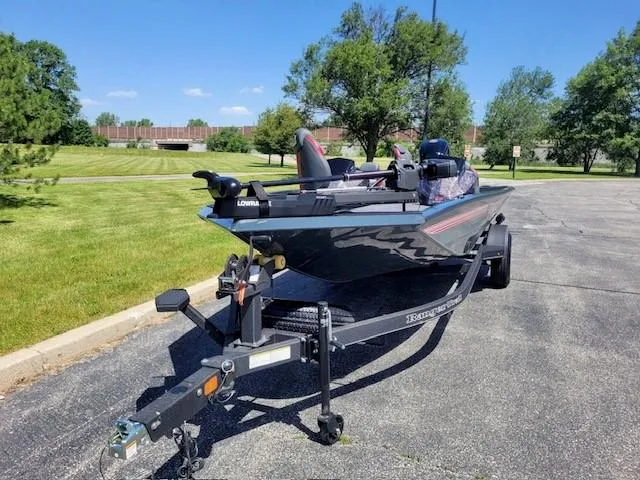 Slide: The Image of 2024 Ranger RT188P fishing boat on trailer in a parking lot. - 1