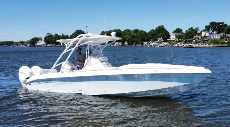 Slide: The Image of 2020 Glasstream 280 SCX boat cruising on a lake with scenic shoreline. - 12
