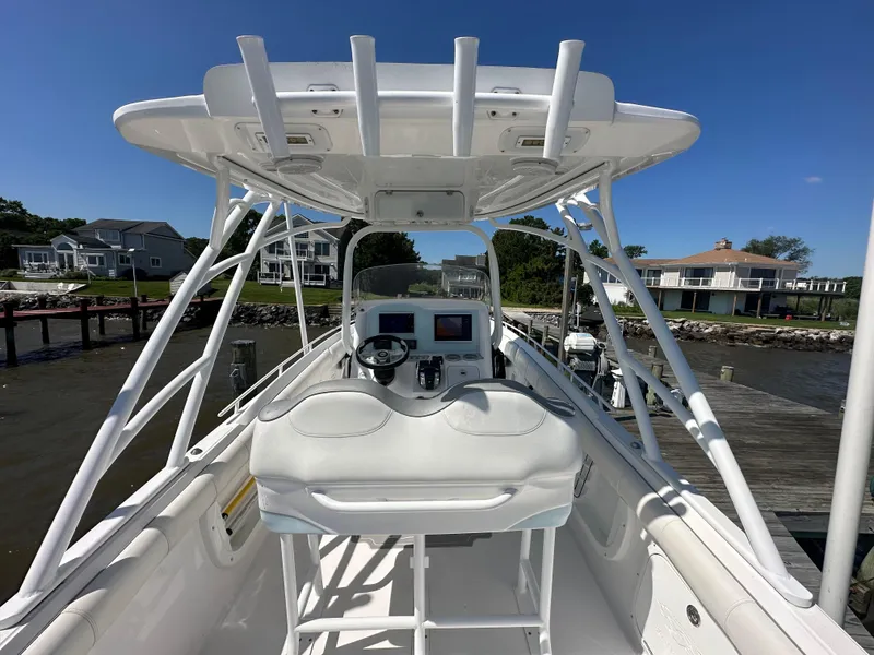 Slide: The Image of 2020 Glasstream 280 SCX boat interior with helm station and waterfront homes in background. - 17