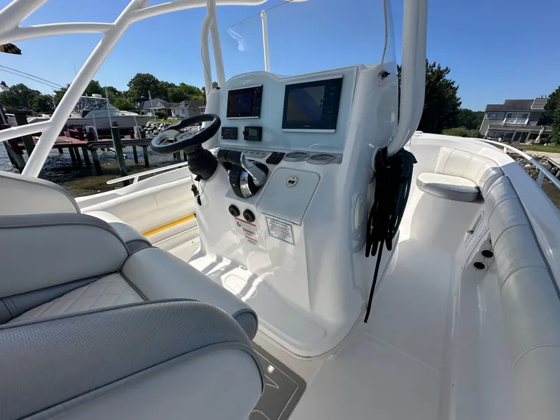 Slide: The Image of 2020 Glasstream 280 SCX boat interior with steering console and navigation screens. - 18