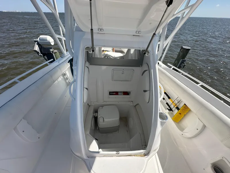 Slide: The Image of 2020 Glasstream 280 SCX boat with open cabin and portable toilet, docked on water. - 28