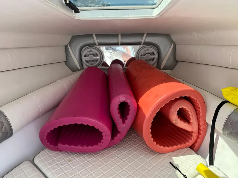 Slide: The Image of Interior of 2020 Glasstream 280 SCX boat with rolled-up pink and orange mats. - 33