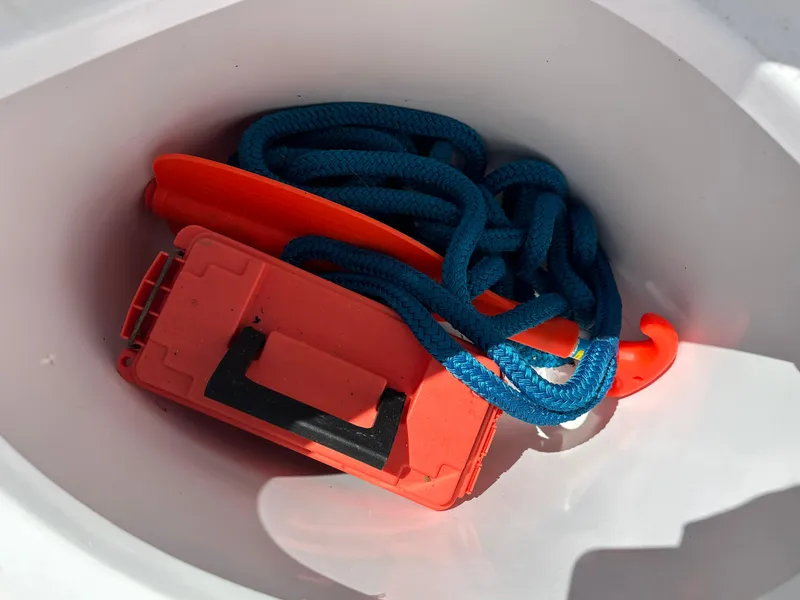 Slide: The Image of Storage compartment of 2020 Glasstream 280 SCX with blue rope and orange safety equipment. - 35