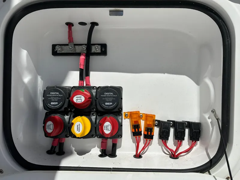 Slide: The Image of Electrical panel of a 2020 Glasstream 280 SCX boat with battery switches and fuses. - 38