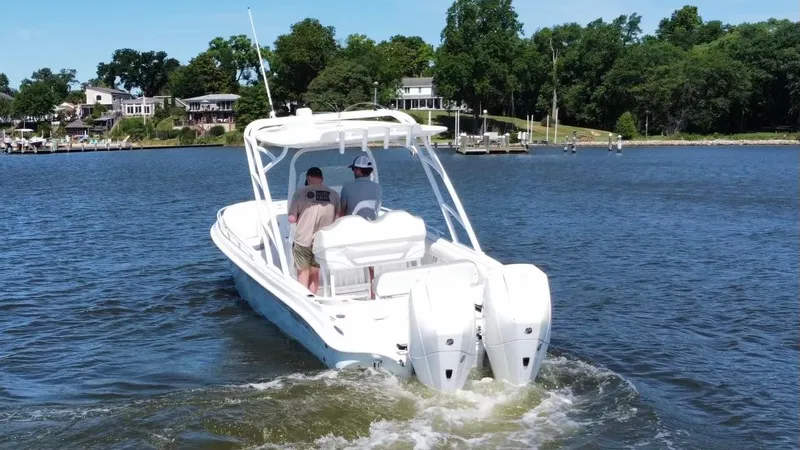Slide: The Image of 2020 Glasstream 280 SCX boat cruising on a lake with two people onboard. - 4