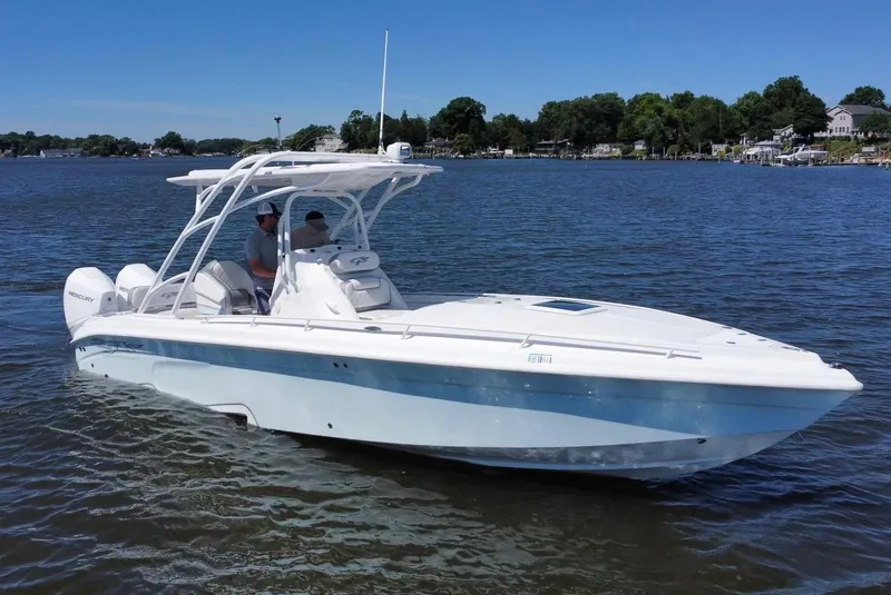 Slide: The Image of 2020 Glasstream 280 SCX boat on calm water with two people onboard. - 5