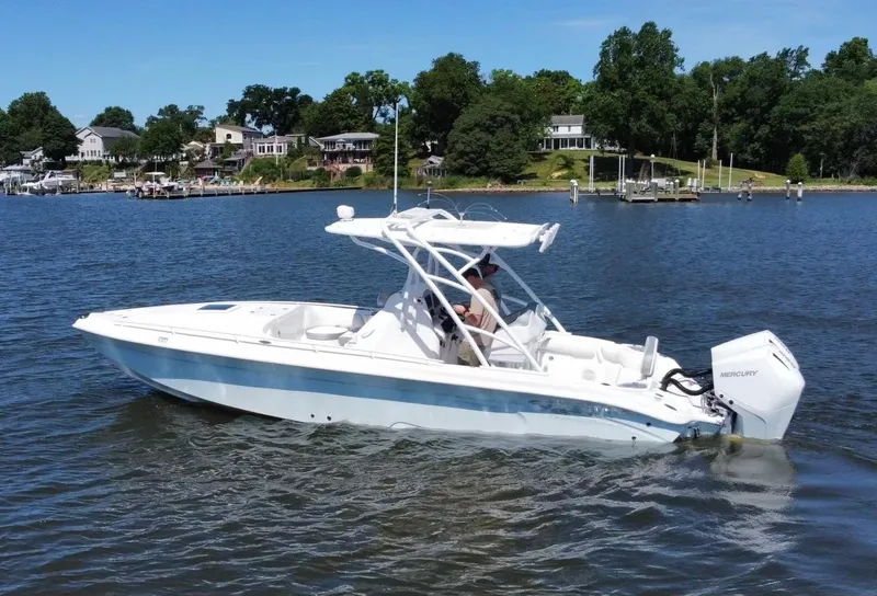 Slide: The Image of 2020 Glasstream 280 SCX boat cruising on a lake with houses in the background. - 6