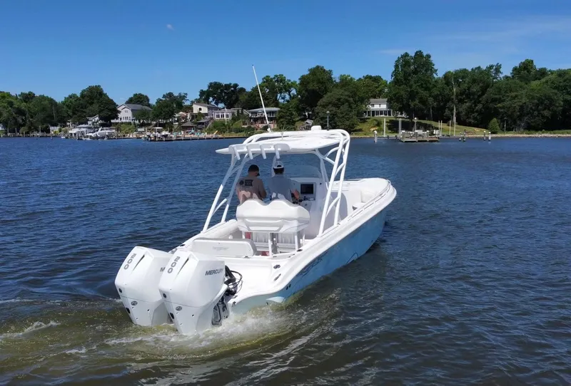 Slide: The Image of 2020 Glasstream 280 SCX boat cruising on a lake with twin Mercury outboard engines. - 8