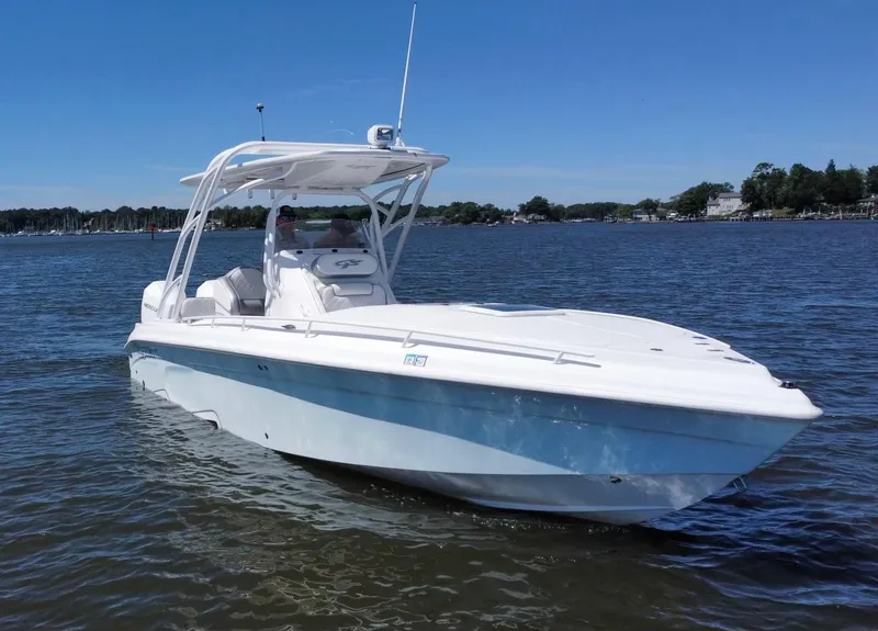Slide: The Image of 2020 Glasstream 280 SCX boat cruising on a calm lake under a clear blue sky. - 9