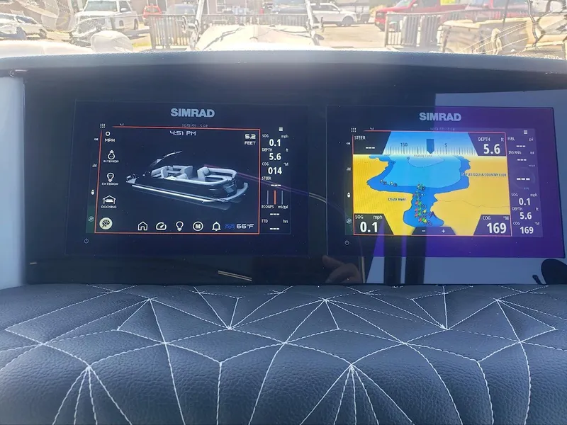 Slide: The Image of Simrad navigation screens on 2023 Harris Grand Mariner 230 boat dashboard. - 2
